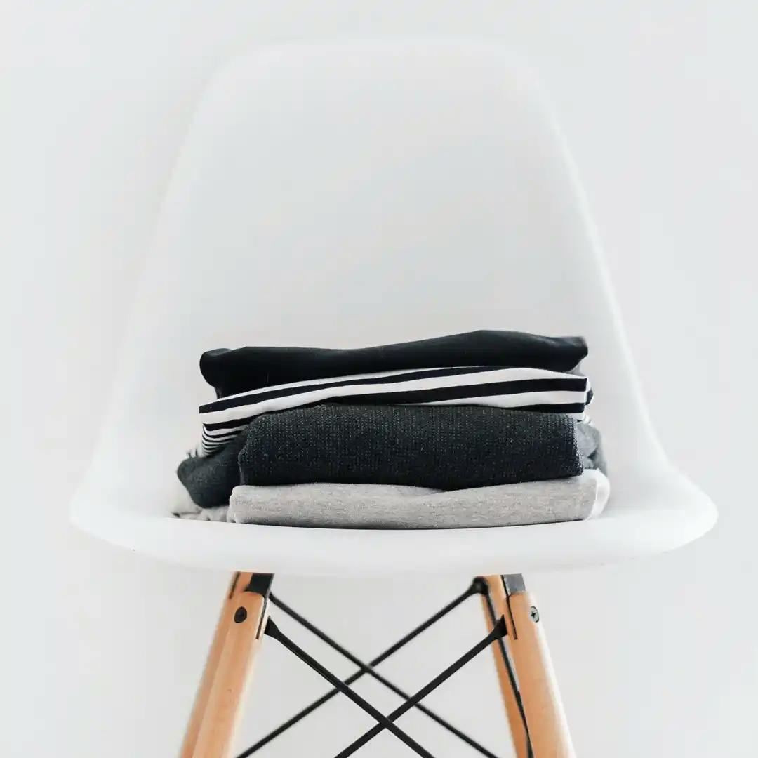 A photo of clothes folder on a chair